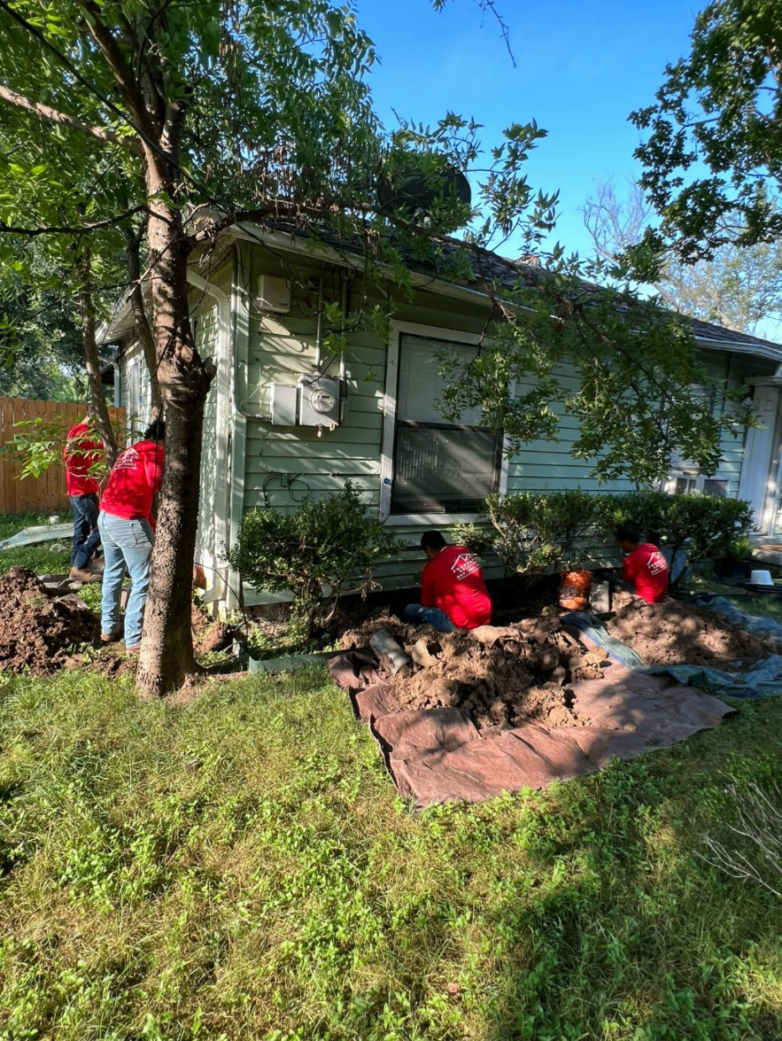 NTX crew performing exterior foundation repair around a home