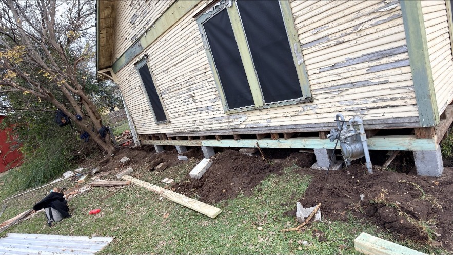 New support beam and piers installed along an older home
