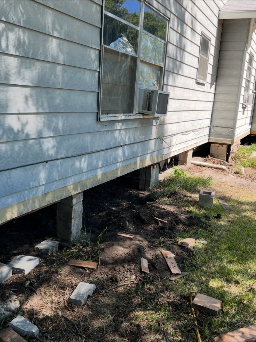 Home raised on new concrete piers during house leveling
