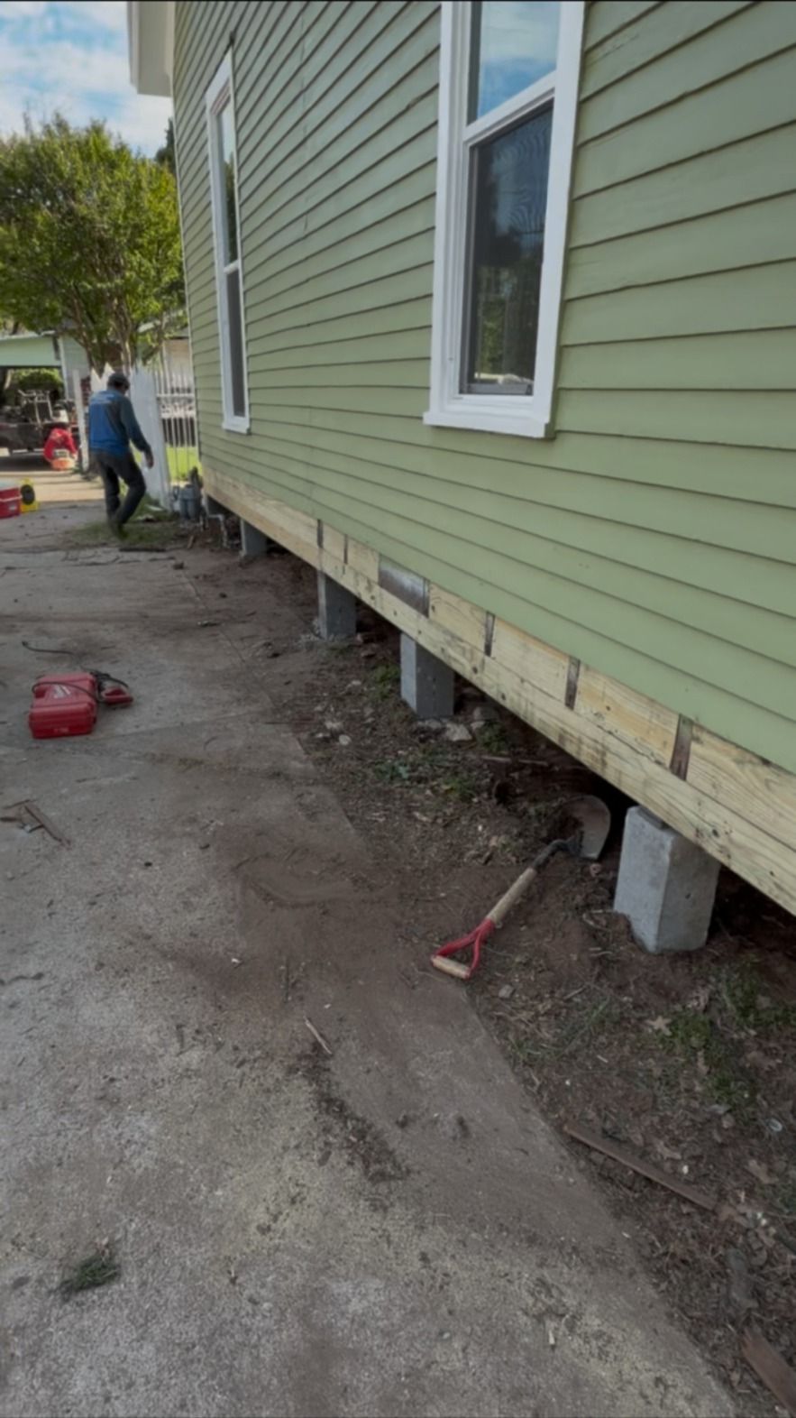 New sill beam and block piers under a green home